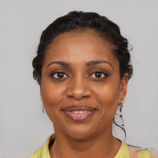 Joyful black young-adult female with short  brown hair and brown eyes