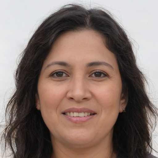 Joyful white adult female with long  brown hair and brown eyes