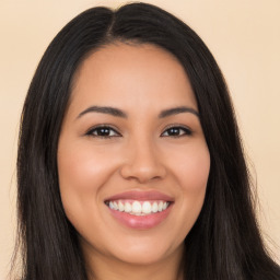 Joyful latino young-adult female with long  brown hair and brown eyes