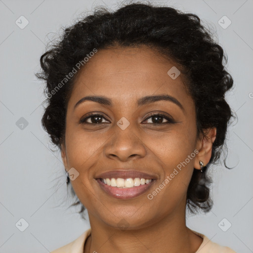 Joyful black young-adult female with long  brown hair and brown eyes