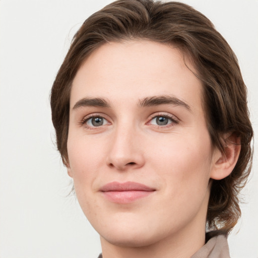 Joyful white young-adult female with medium  brown hair and green eyes