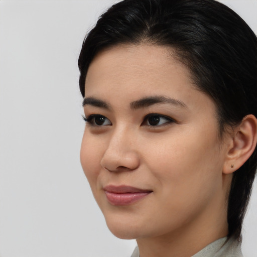 Joyful asian young-adult female with medium  black hair and brown eyes