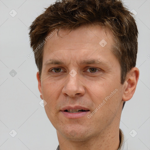 Joyful white adult male with short  brown hair and brown eyes