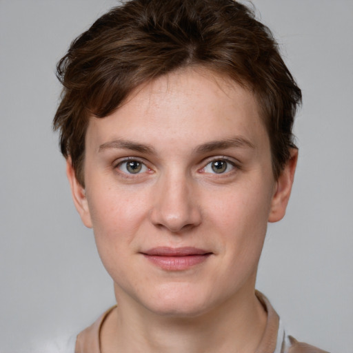 Joyful white young-adult female with short  brown hair and grey eyes