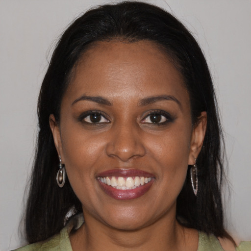 Joyful black young-adult female with medium  brown hair and brown eyes