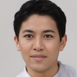 Joyful asian young-adult male with short  black hair and brown eyes