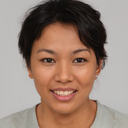 Joyful asian young-adult female with short  brown hair and brown eyes