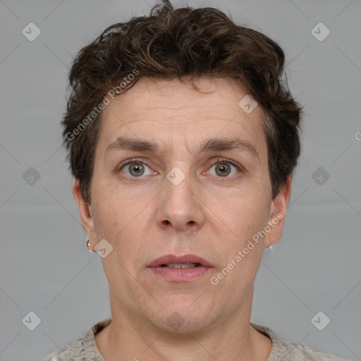 Joyful white adult male with short  brown hair and grey eyes