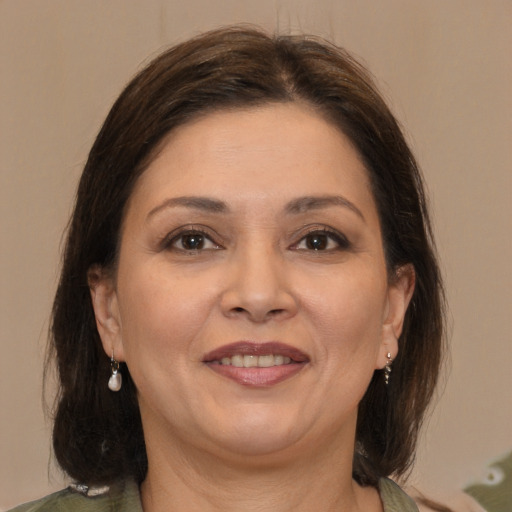 Joyful white adult female with medium  brown hair and brown eyes