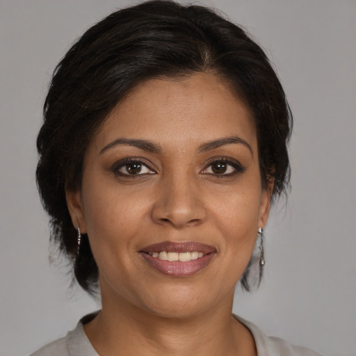Joyful black young-adult female with medium  brown hair and brown eyes