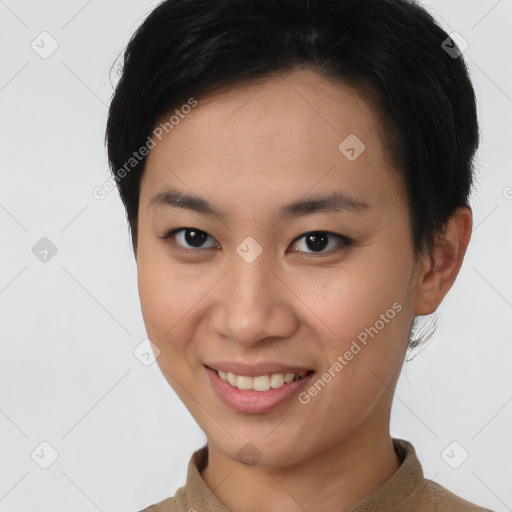 Joyful asian young-adult female with short  black hair and brown eyes