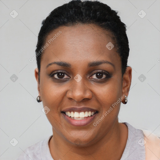 Joyful black young-adult female with short  black hair and brown eyes