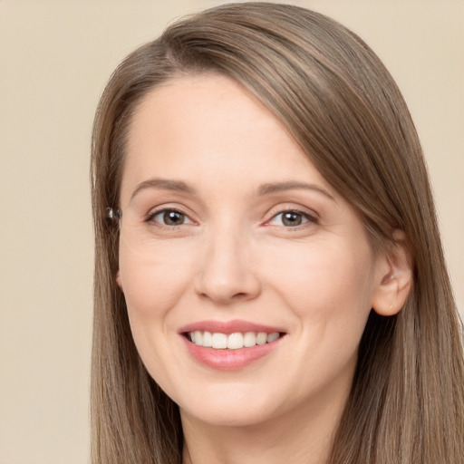 Joyful white young-adult female with long  brown hair and brown eyes