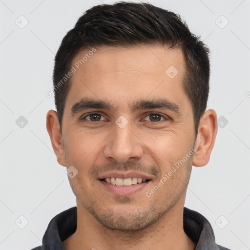 Joyful white young-adult male with short  black hair and brown eyes