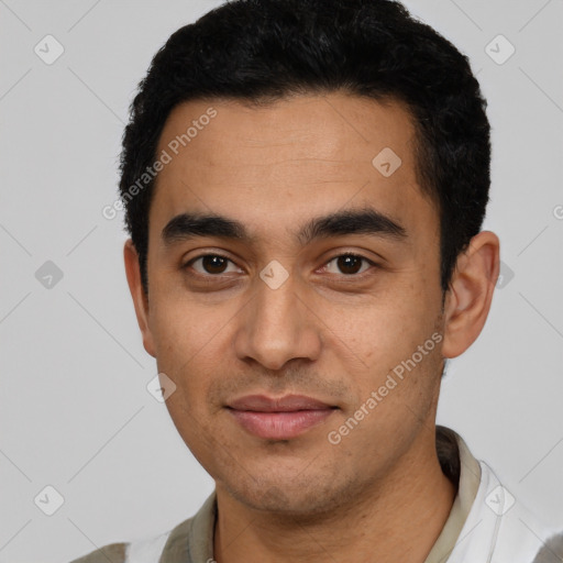 Joyful latino young-adult male with short  black hair and brown eyes