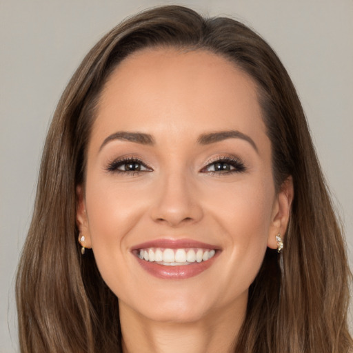 Joyful white young-adult female with long  brown hair and brown eyes