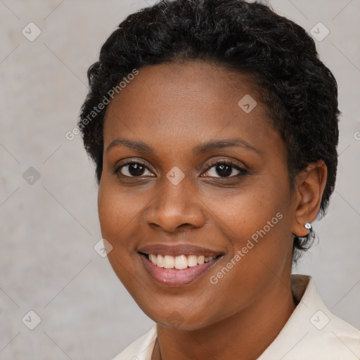 Joyful black young-adult female with short  brown hair and brown eyes