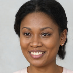 Joyful black young-adult female with medium  brown hair and brown eyes