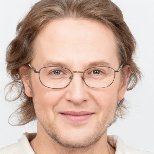 Joyful white adult male with medium  brown hair and grey eyes