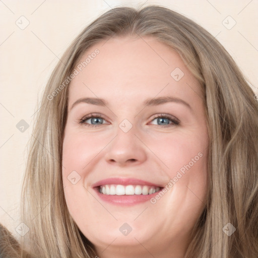 Joyful white young-adult female with long  brown hair and blue eyes