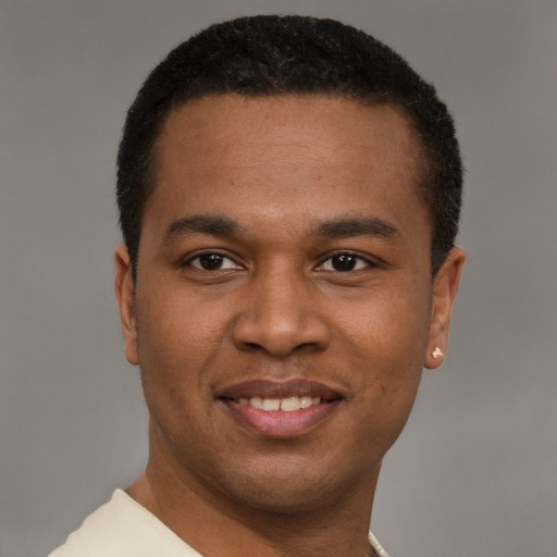 Joyful latino young-adult male with short  brown hair and brown eyes