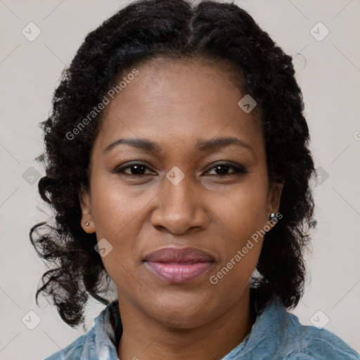 Joyful black adult female with medium  brown hair and brown eyes