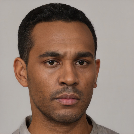 Neutral latino young-adult male with short  black hair and brown eyes