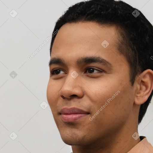 Joyful latino young-adult male with short  black hair and brown eyes