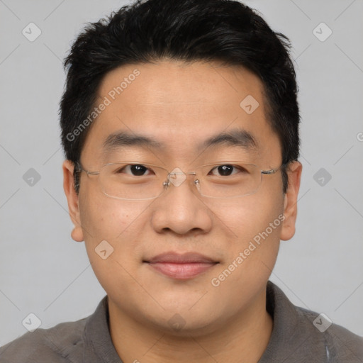 Joyful asian young-adult male with short  black hair and brown eyes