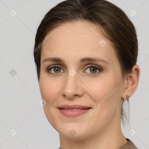 Joyful white young-adult female with medium  brown hair and grey eyes