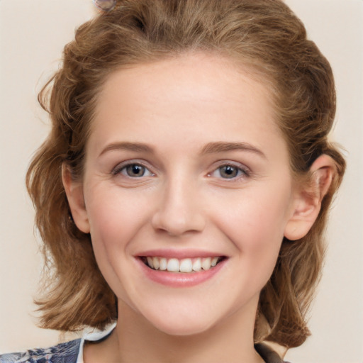 Joyful white young-adult female with medium  brown hair and blue eyes