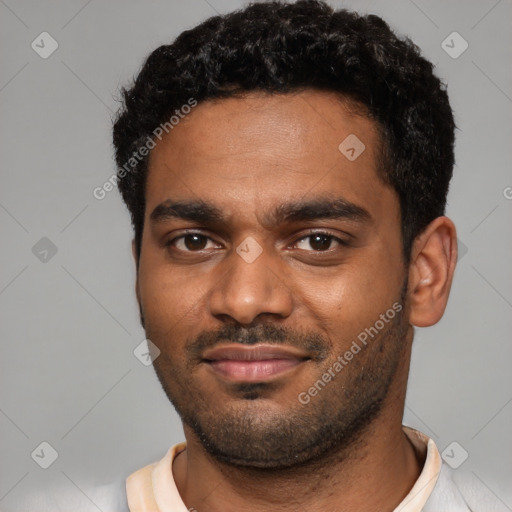 Joyful black young-adult male with short  black hair and brown eyes