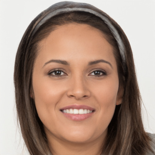 Joyful white young-adult female with long  brown hair and brown eyes