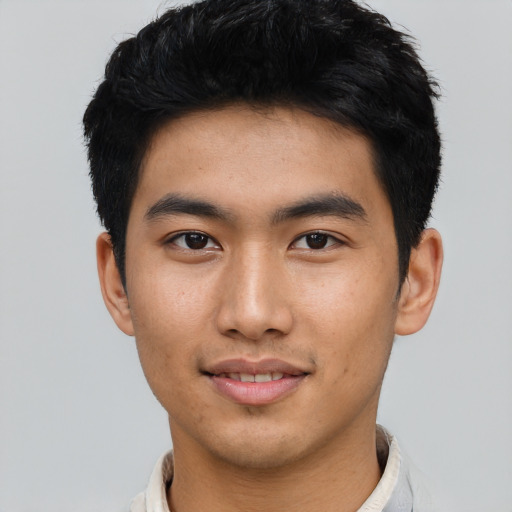 Joyful asian young-adult male with short  black hair and brown eyes