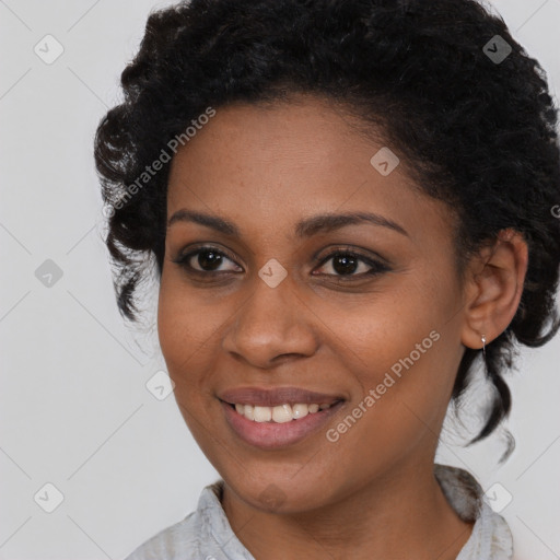 Joyful black young-adult female with medium  brown hair and brown eyes