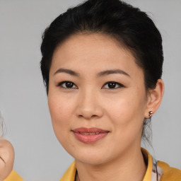 Joyful asian young-adult female with medium  brown hair and brown eyes