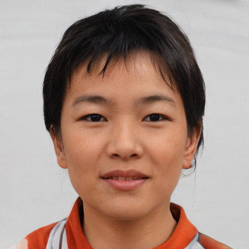 Joyful asian young-adult female with short  brown hair and brown eyes