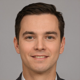 Joyful white young-adult male with short  brown hair and brown eyes