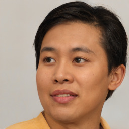 Joyful asian young-adult male with short  brown hair and brown eyes