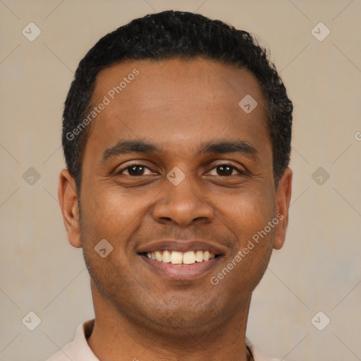 Joyful black young-adult male with short  brown hair and brown eyes