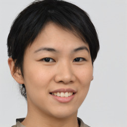 Joyful asian young-adult female with short  brown hair and brown eyes