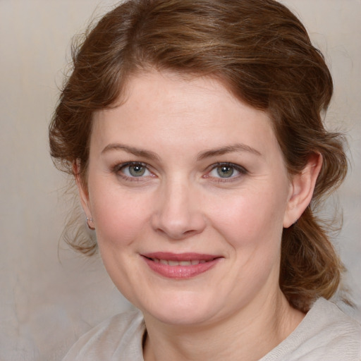 Joyful white young-adult female with medium  brown hair and blue eyes