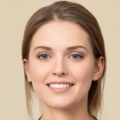 Joyful white young-adult female with long  brown hair and grey eyes