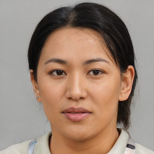 Joyful asian young-adult female with medium  brown hair and brown eyes