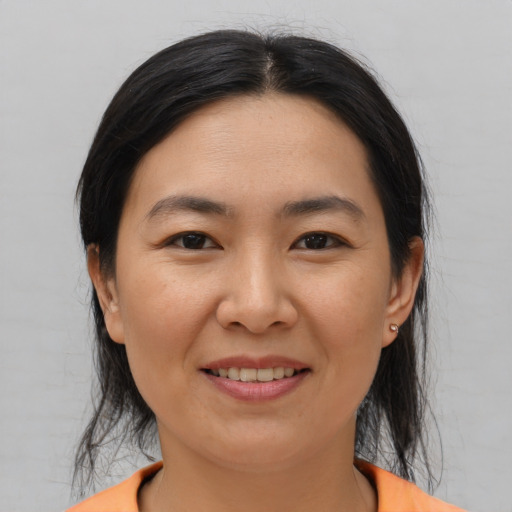 Joyful asian young-adult female with medium  black hair and brown eyes