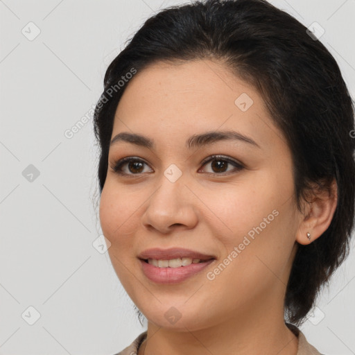 Joyful latino young-adult female with medium  brown hair and brown eyes