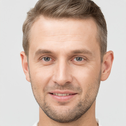 Joyful white adult male with short  brown hair and brown eyes