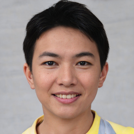 Joyful asian young-adult male with short  black hair and brown eyes