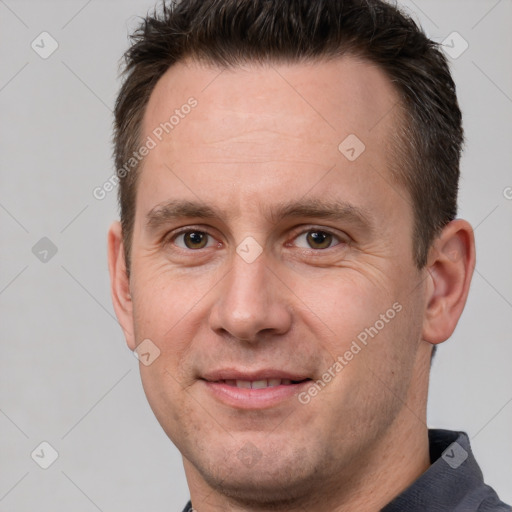 Joyful white adult male with short  brown hair and brown eyes