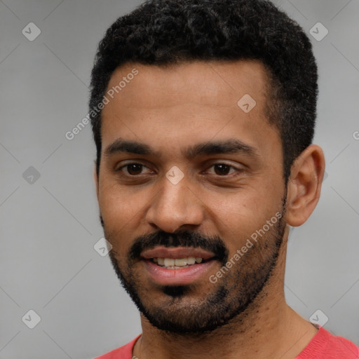 Joyful black young-adult male with short  black hair and brown eyes